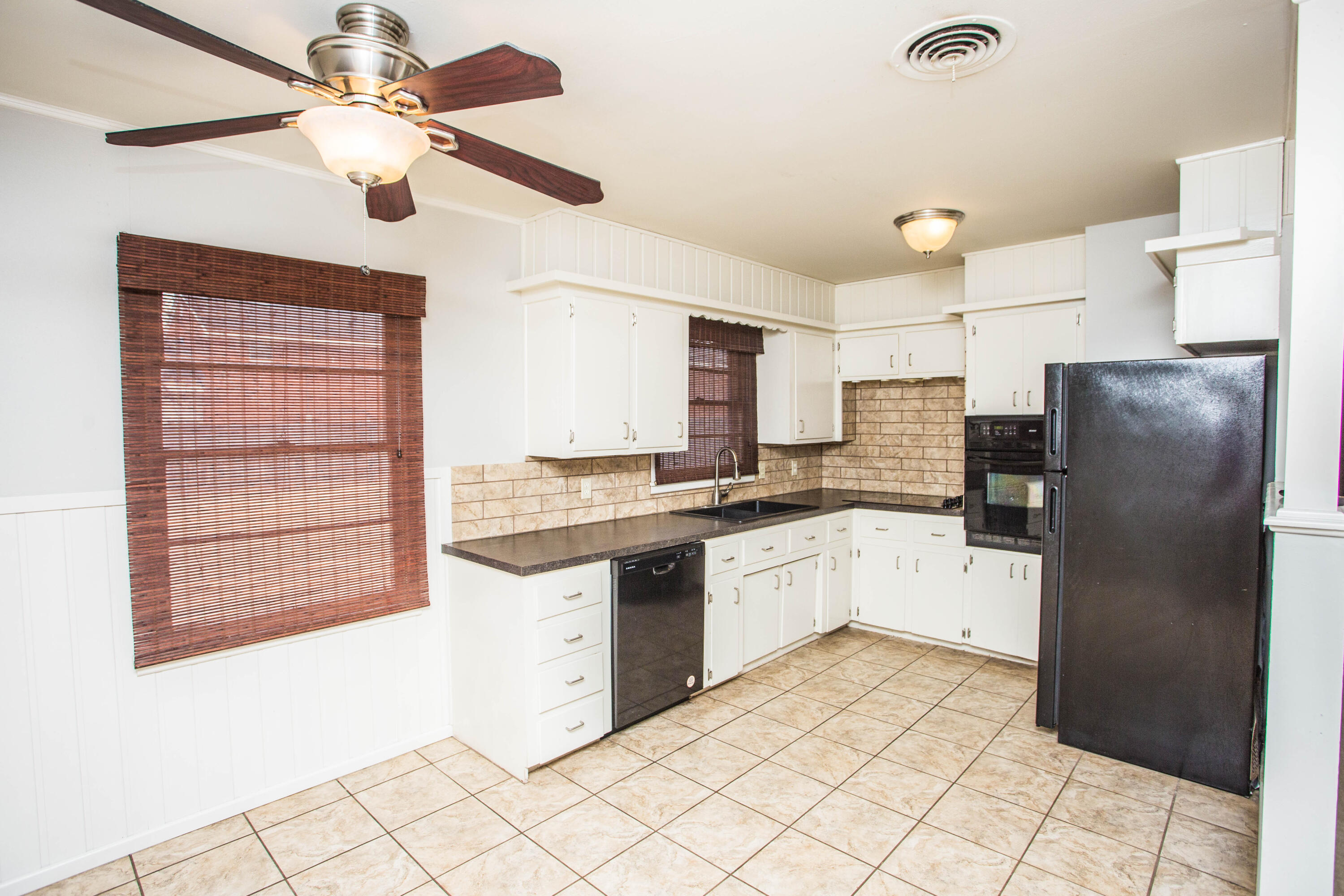 4932 9th Street Lubbock, TX 79416 - Photo 4 of 29 a kitchen with stainless steel appliances granite countertop a refrigerator and a sink