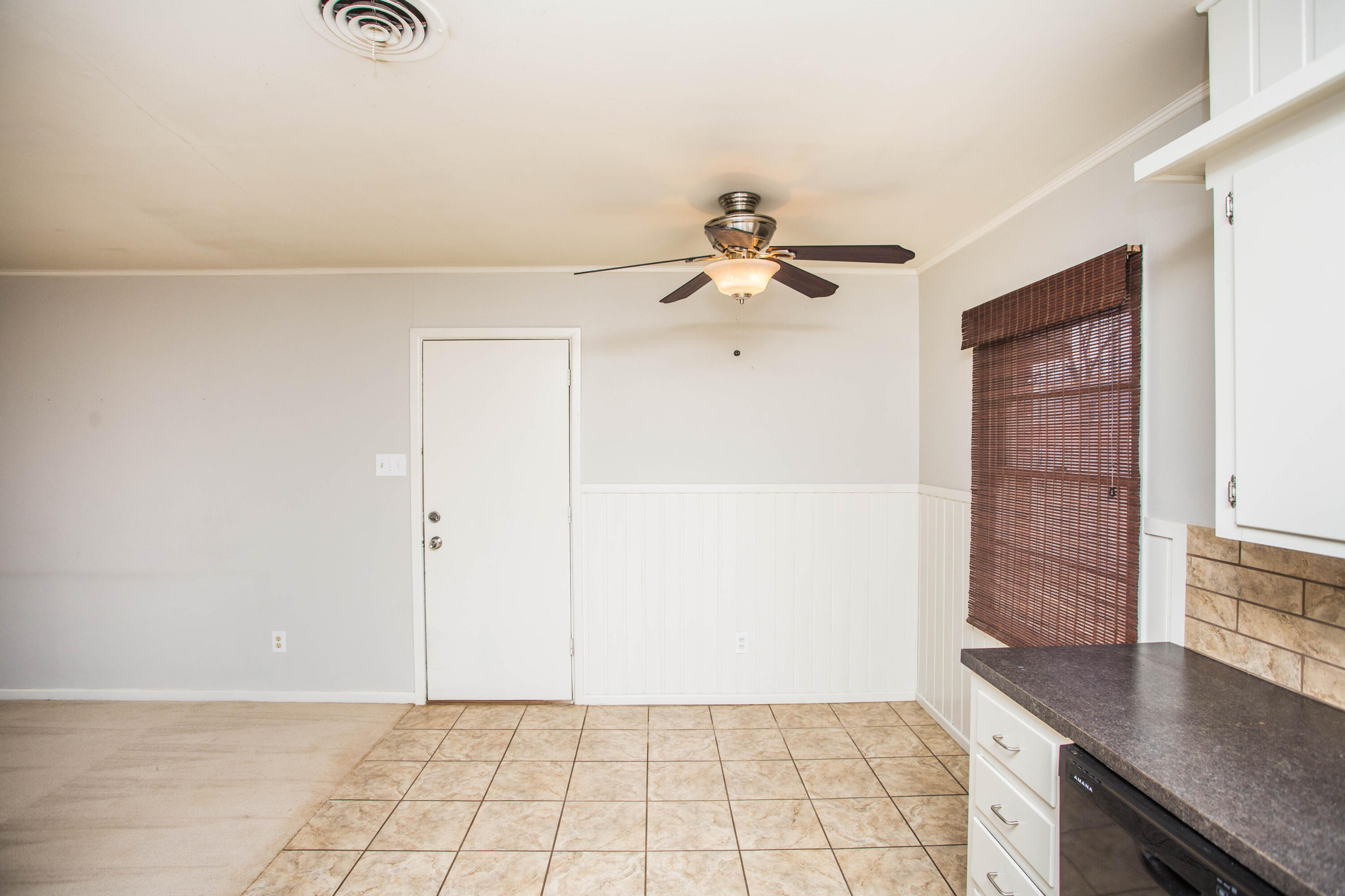 4932 9th Street Lubbock, TX 79416 - Photo 6 of 29 an empty room with windows and fan