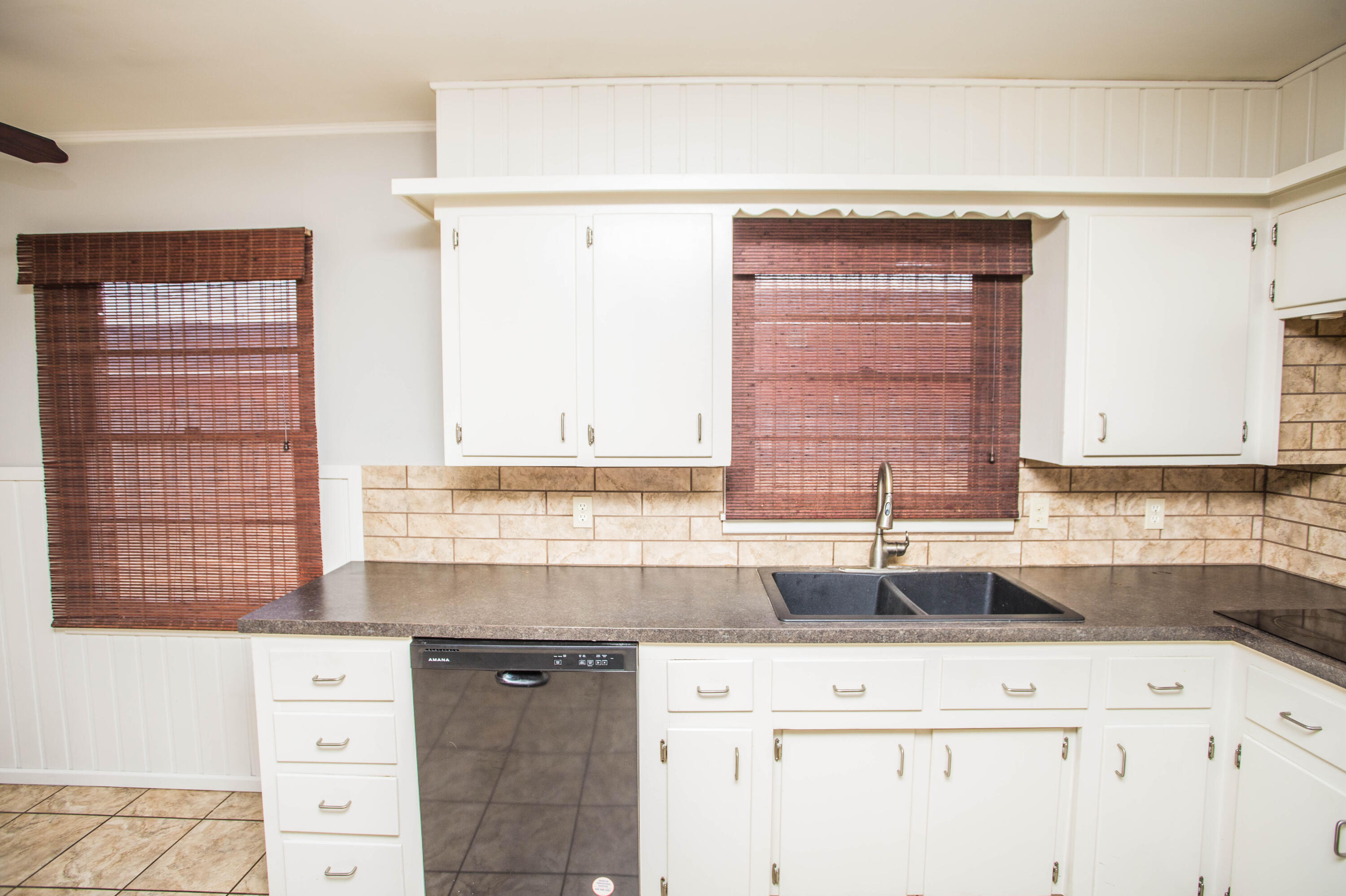 4932 9th Street Lubbock, TX 79416 - Photo 7 of 29 a kitchen with cabinets appliances and a window