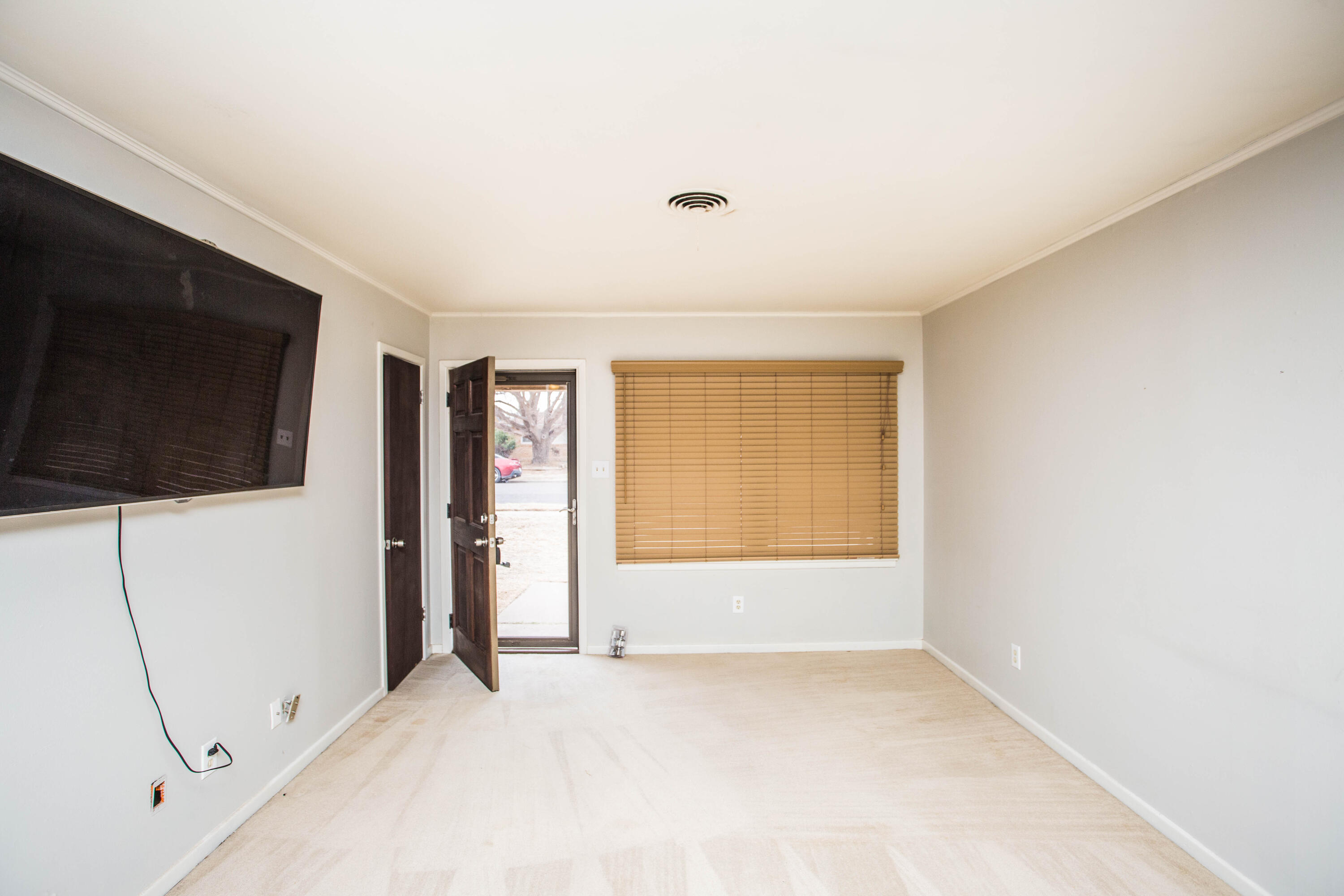 4932 9th Street Lubbock, TX 79416 - Photo 8 of 29 a view of an empty room with wooden floor and windows