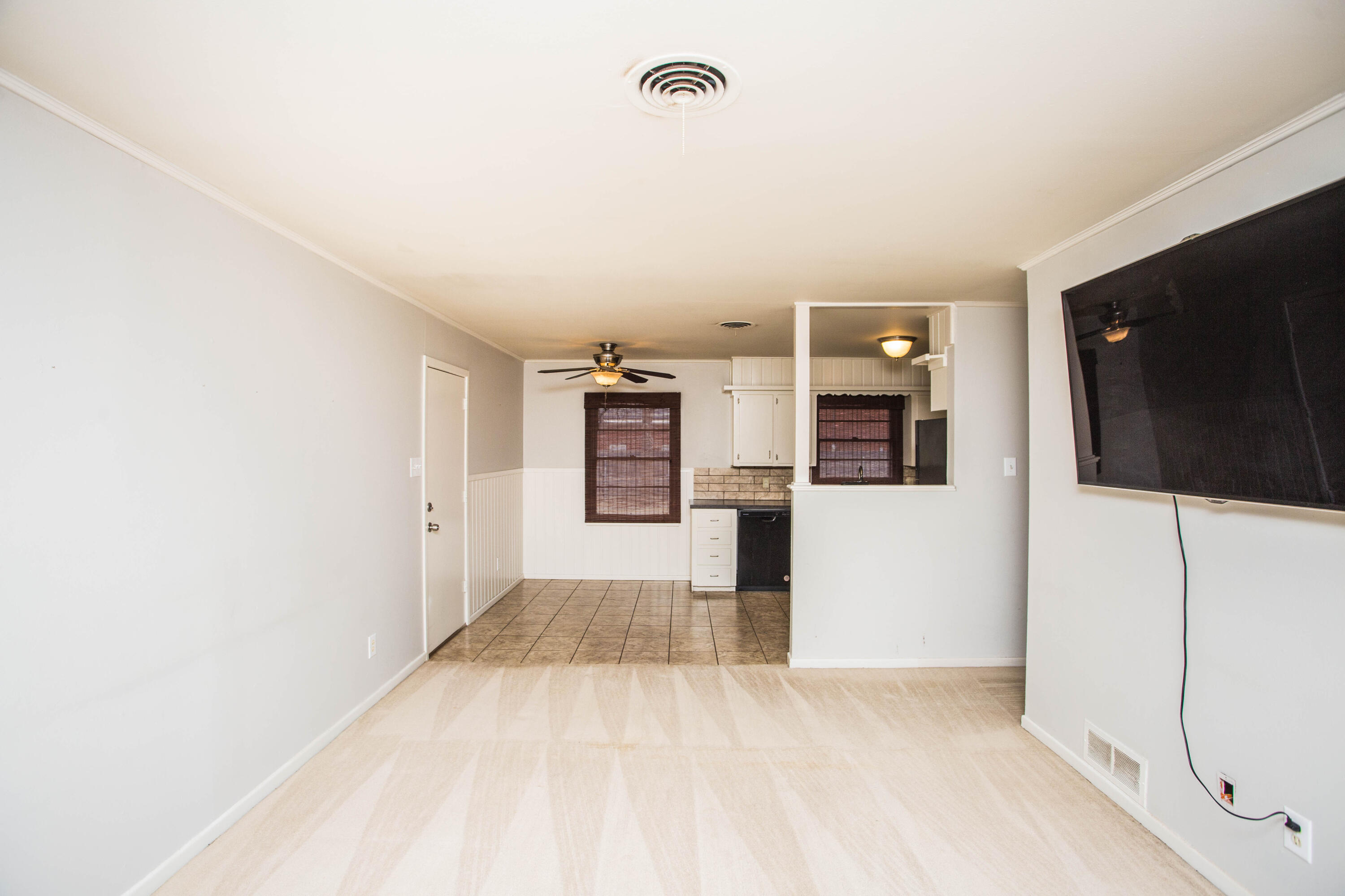 4932 9th Street Lubbock, TX 79416 - Photo 9 of 29 a view of a kitchen with refrigerator and a stove