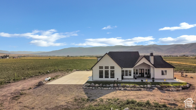 1952 Highway 118 Monroe, UT 84754 - Photo 75 of 88 Back of house featuring a patio area, a mountain view, gravel driveway, and stucco siding