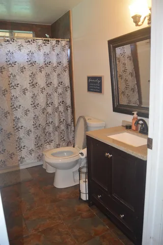 a bathroom with a sink toilet and mirror