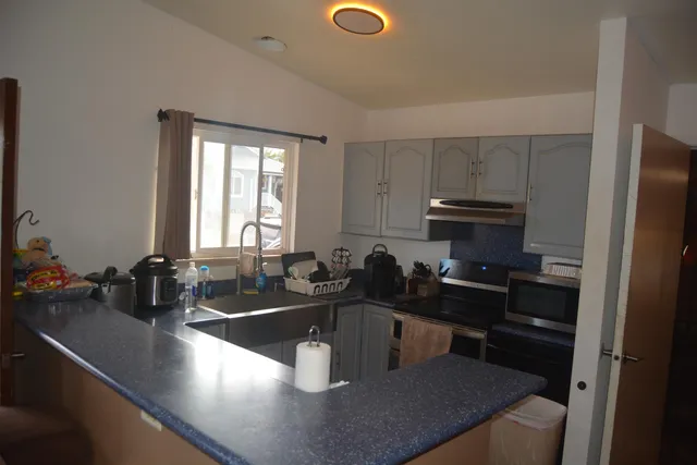 a kitchen with a sink a stove and a refrigerator