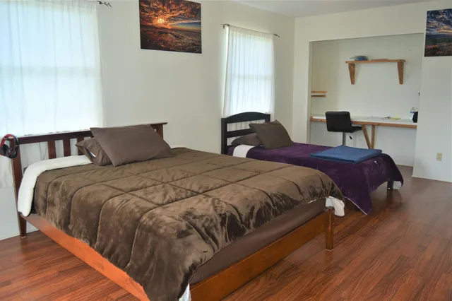 a bedroom with double bed and a night stand