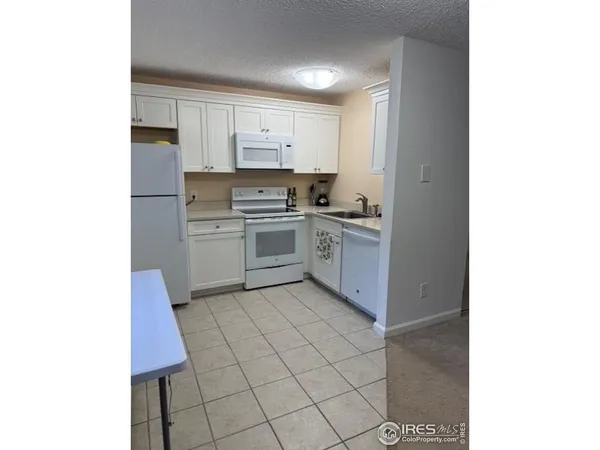 a kitchen with a stove a sink and a refrigerator