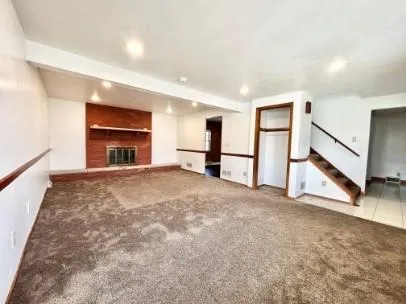 a view of an empty room with a fireplace