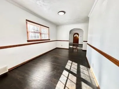 a view of a hallway view with wooden floor and furniture