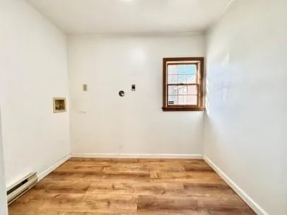 a view of a big room with wooden floor and windows