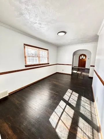a view of a living room with hardwood floor and window