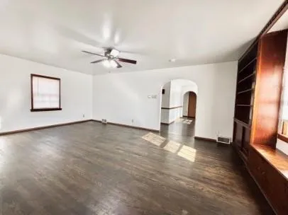 wooden floor in an empty room with a window