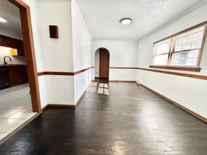 a view of a hardwood floor in an empty room