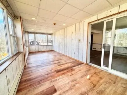 a big room with wooden floor and windows