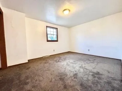 an empty room with a empty space and window