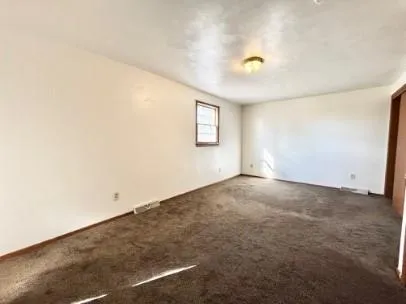 an empty room with a empty space and windows