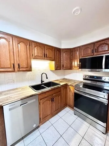 a kitchen with stainless steel appliances granite countertop a sink and a stove