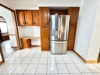 a kitchen with stainless steel appliances granite countertop a refrigerator and a stove