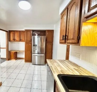 a kitchen with kitchen island granite countertop a stove a sink and a refrigerator