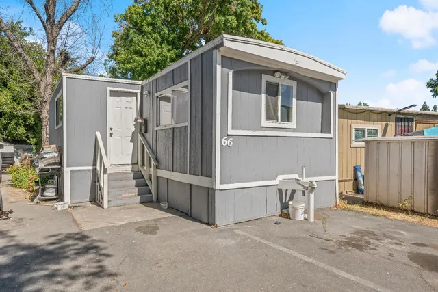 a view of a house with wooden wall and roof