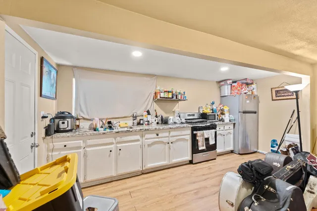 a kitchen with a sink stove and cabinets