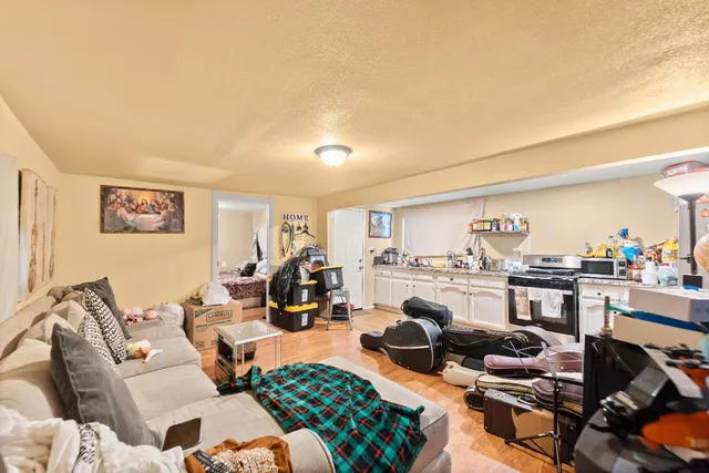 a living room with furniture a rug and a table