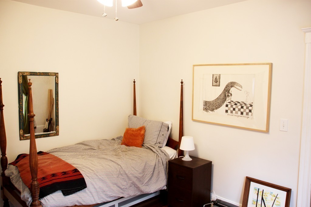80 Aldrich Street, Unit 2 Boston, MA 02131 - Photo 17 of 20 a bedroom with a bed and a mirror on dresser