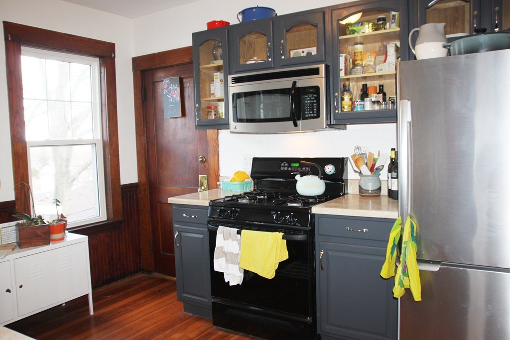 80 Aldrich Street, Unit 2 Boston, MA 02131 - Photo 3 of 20 a kitchen with stainless steel appliances granite countertop a refrigerator and a stove top oven