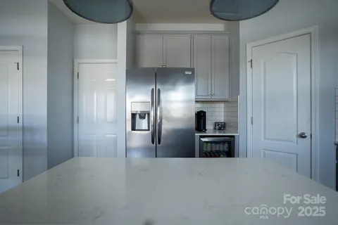 a kitchen with granite countertop a refrigerator and a stove