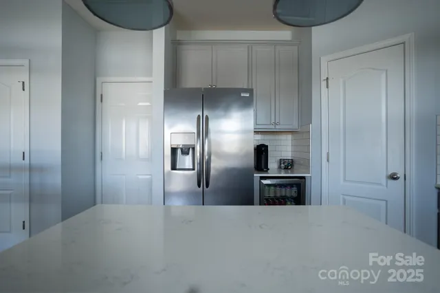 a kitchen with granite countertop a refrigerator and a stove