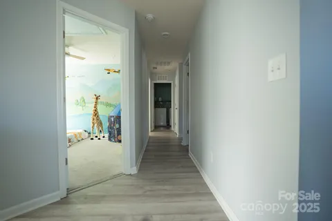 a view of a hallway view with wooden floor and staircase