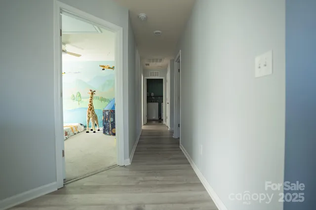 a view of a hallway view with wooden floor and staircase