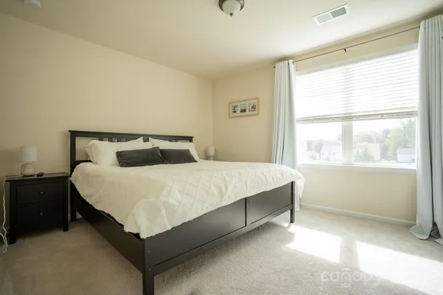 a bedroom with a bed and window