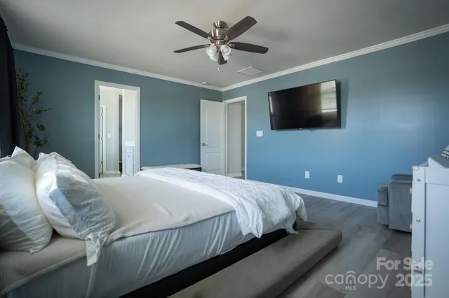 a bedroom with a large bed and a flat screen tv