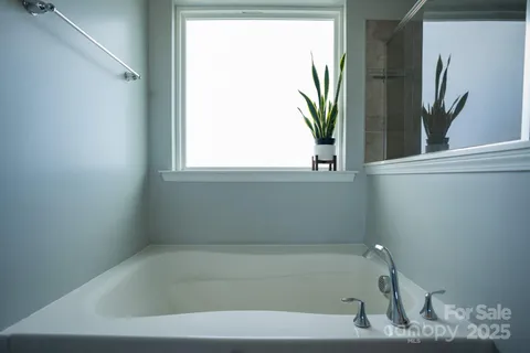 a bathroom with a bathtub and window
