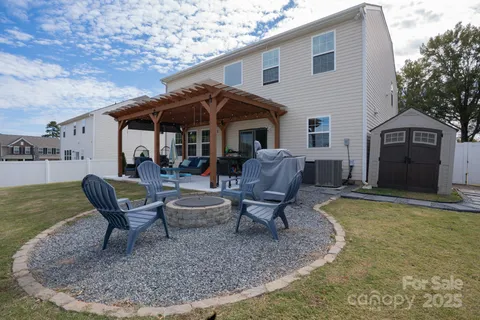 a view of a house with backyard porch and sitting area
