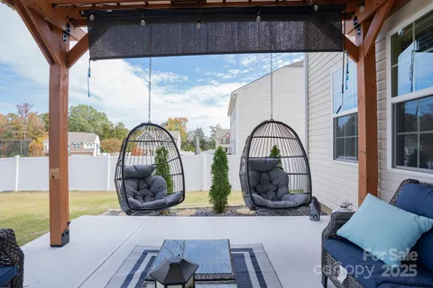 a front view of a house with garden and patio