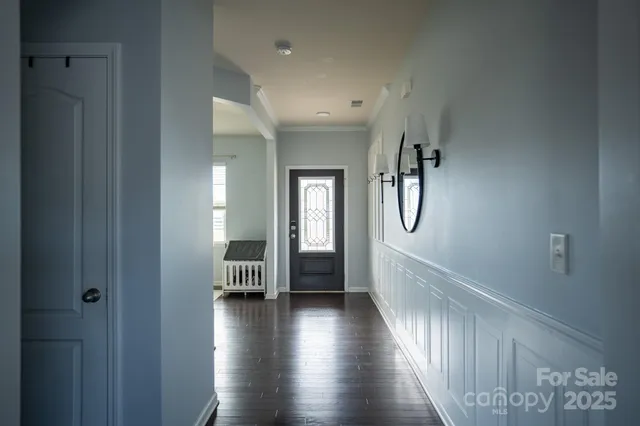 a view of a hallway view with wooden floor and staircase