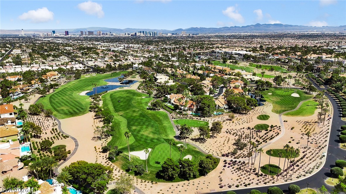 8981 Rivers Edge Drive Las Vegas, NV 89117 - Photo 66 of 69 An aerial panorama reveals a vast golf course community with lush fairways and shimmering water features.