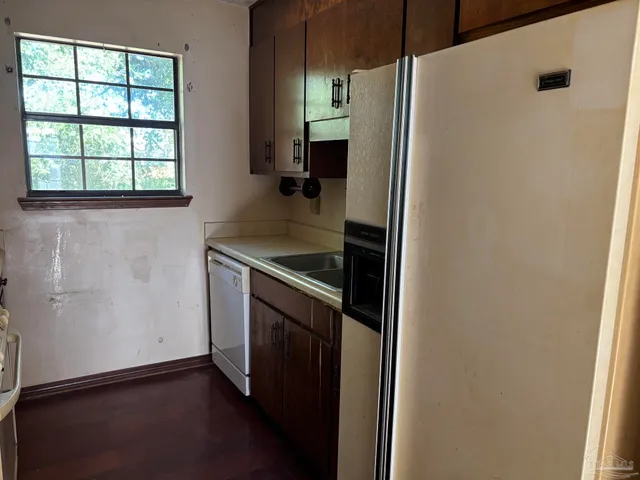 a kitchen with a refrigerator and window