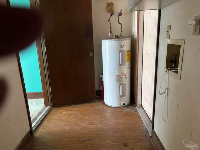 a view of a hallway with wooden cabinets and stairs