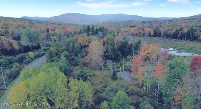 an aerial view of mountains residential house and green space
