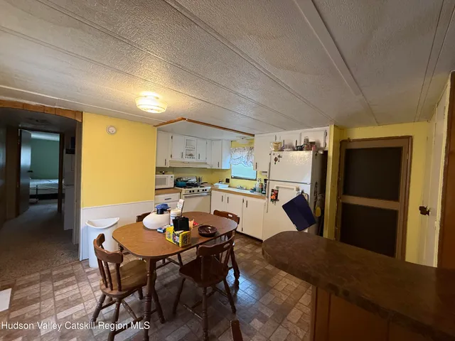 a kitchen with a table and chairs in it