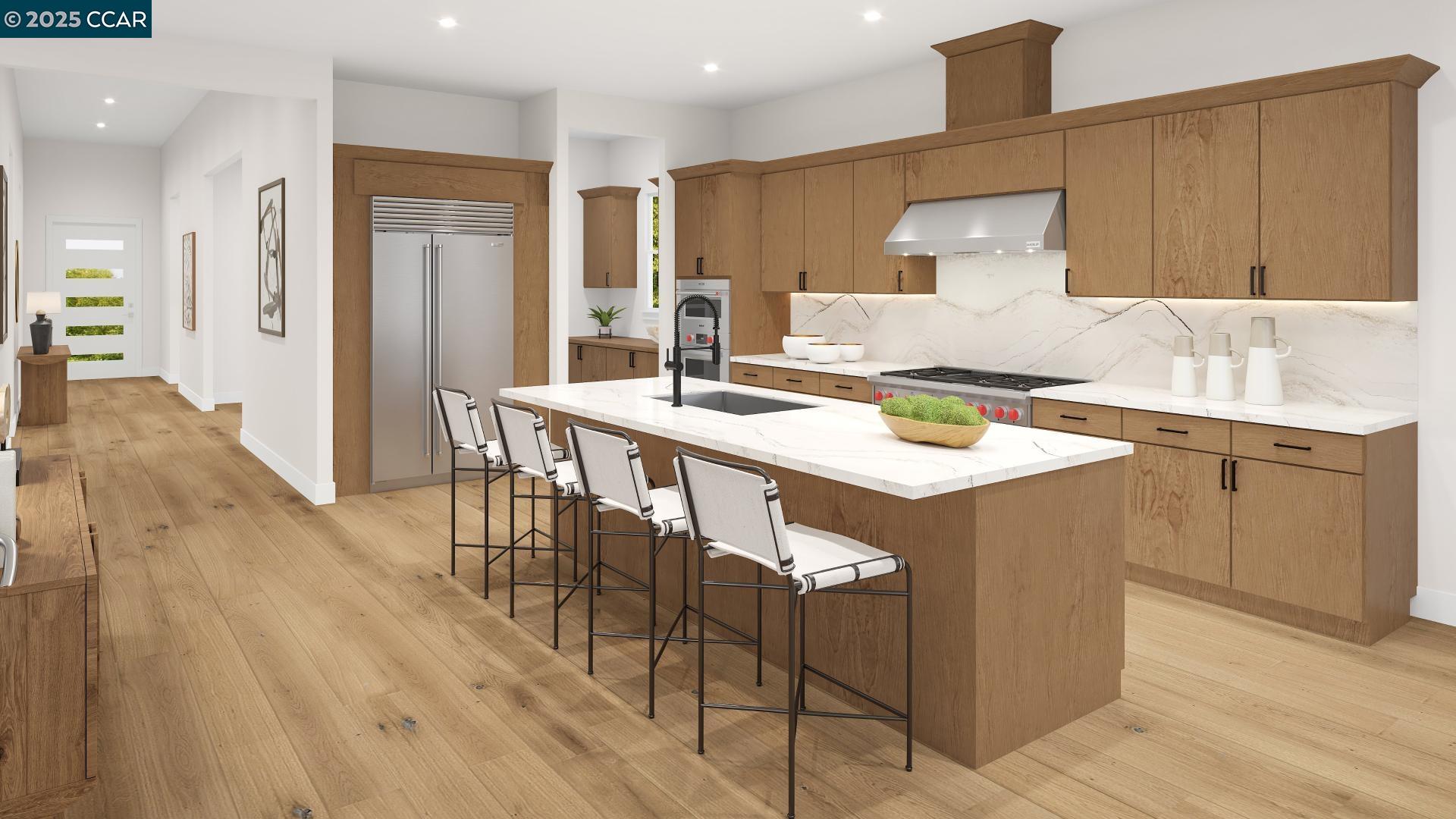 a kitchen with stainless steel appliances stove refrigerator dining table and chairs