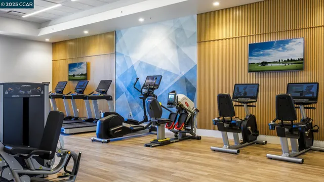 a view of a room with gym equipment and a large window