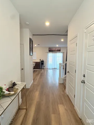 a view of a kitchen with a sink and wooden floor