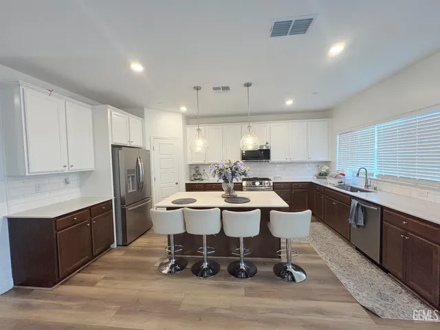 a large kitchen with a table and chairs