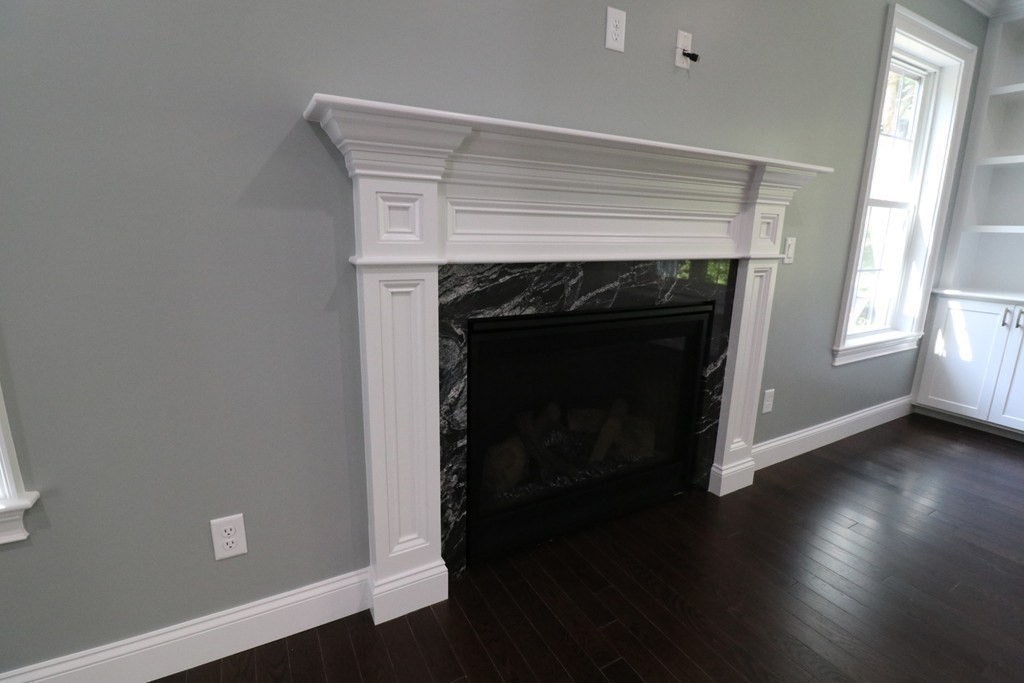 5 West River Street Upton, MA 01568 - Photo 12 of 37 a room with a fireplace and wooden floor