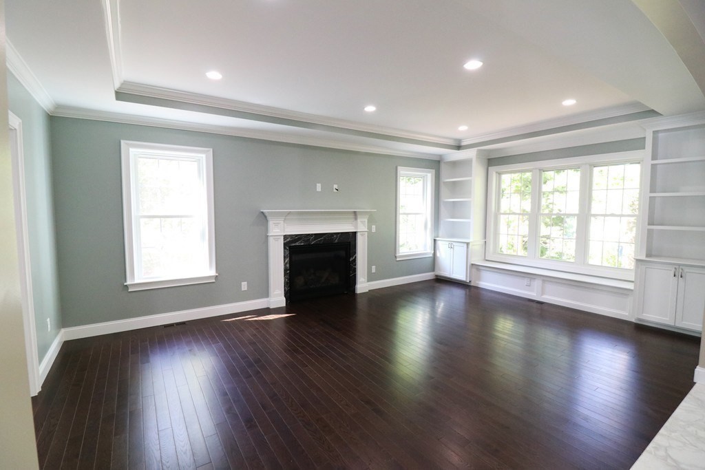 5 West River Street Upton, MA 01568 - Photo 14 of 37 an empty room with wooden floor and windows