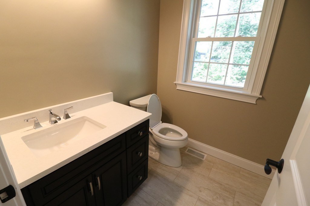 5 West River Street Upton, MA 01568 - Photo 20 of 37 a bathroom with a sink toilet and a window