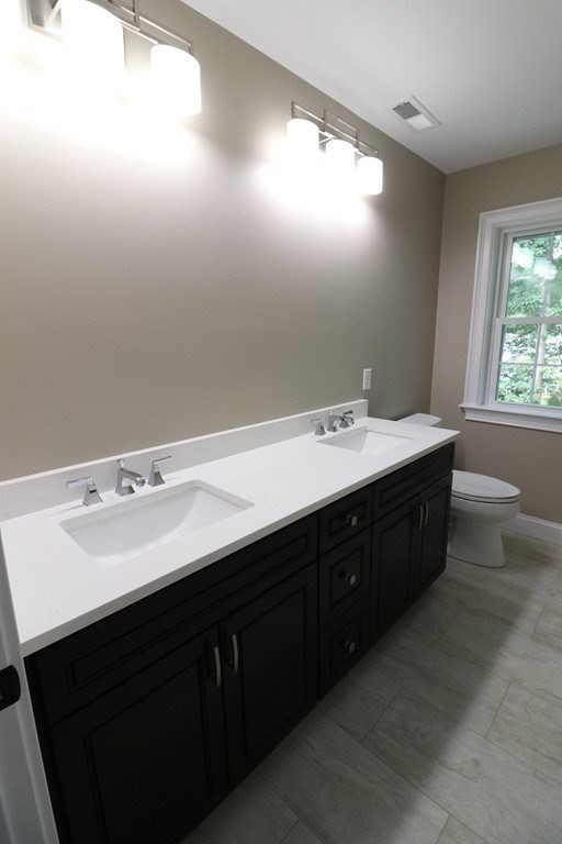 5 West River Street Upton, MA 01568 - Photo 26 of 37 a bathroom with a double vanity sink and mirror